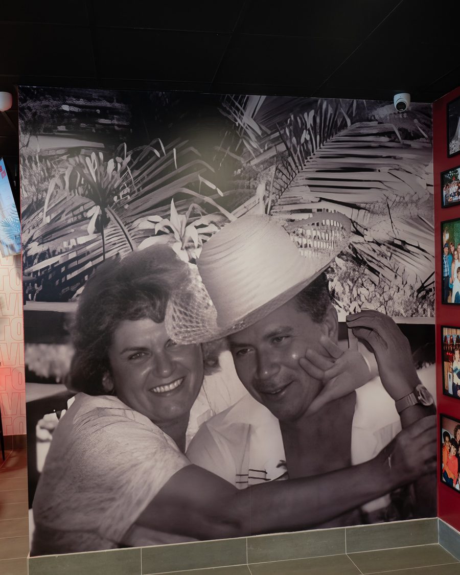 A large black-and-white photograph of a smiling couple, printed on the wall at Bar Victor
